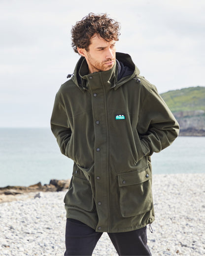 Deep Forest coloured Ridgeline Torrent Waterproof Jacket on beach background 