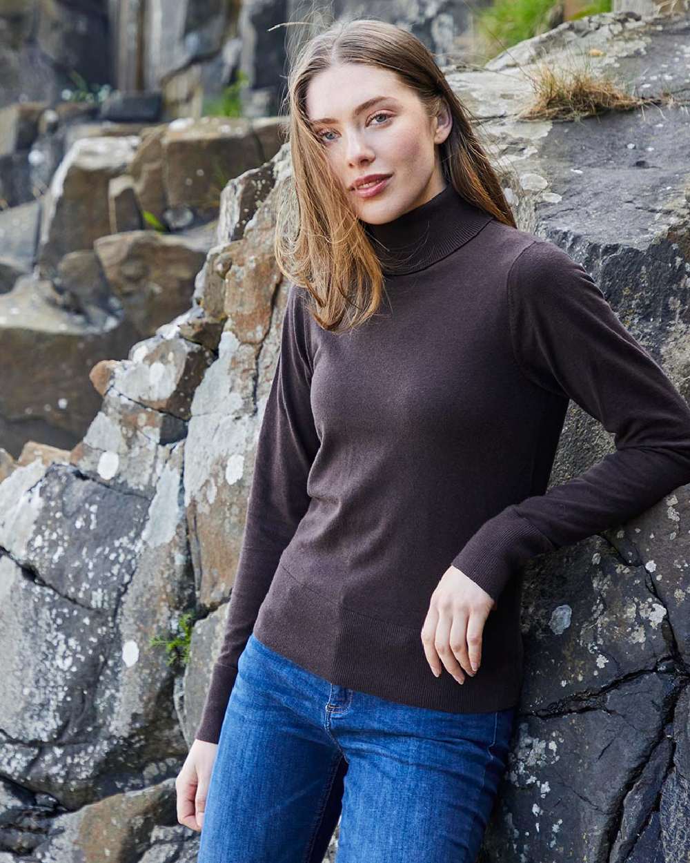 Deep Bark coloured Ridgeline Womens Melford Knit Roll Neck Jumper on rocky background 