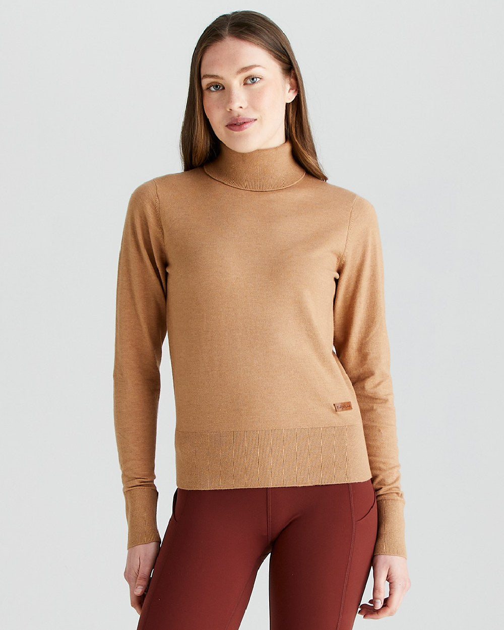 Sienna coloured Ridgeline Womens Melford Knit Roll Neck Jumper on grey background 