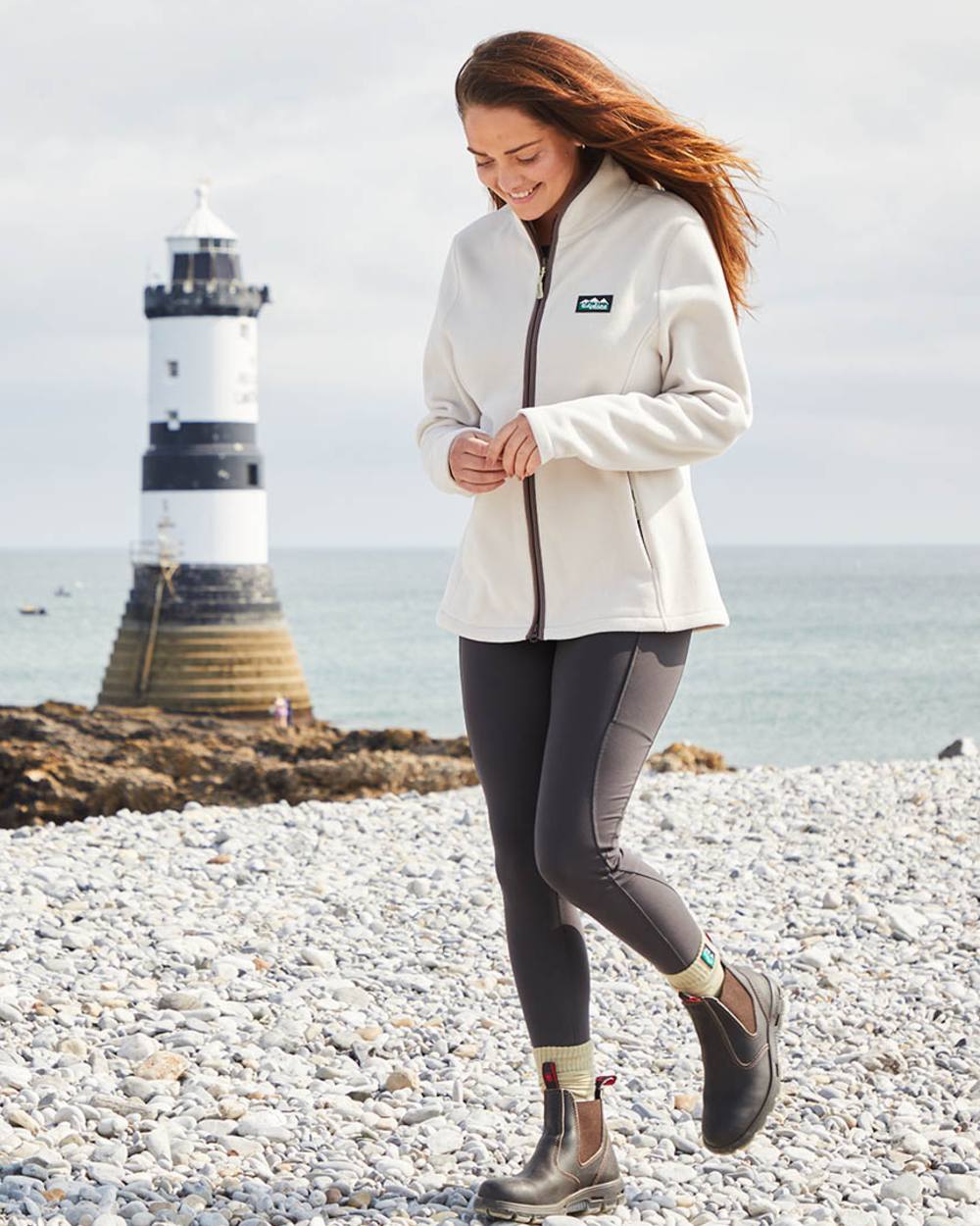 Stone coloured Ridgeline Womens Brenna Fleece Jacket on sea background 
