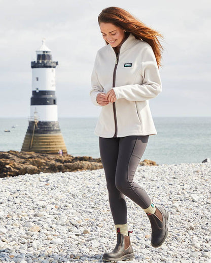 Stone coloured Ridgeline Womens Brenna Fleece Jacket on sea background 