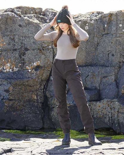 Deep Bark coloured Ridgeline Womens Cambrian Trousers on rocky background 