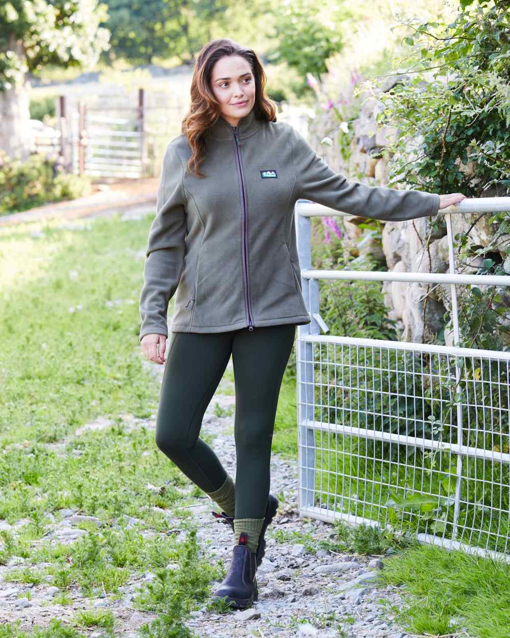 Deep Forest coloured Ridgeline Womens Infinity Leggings on backyard background 