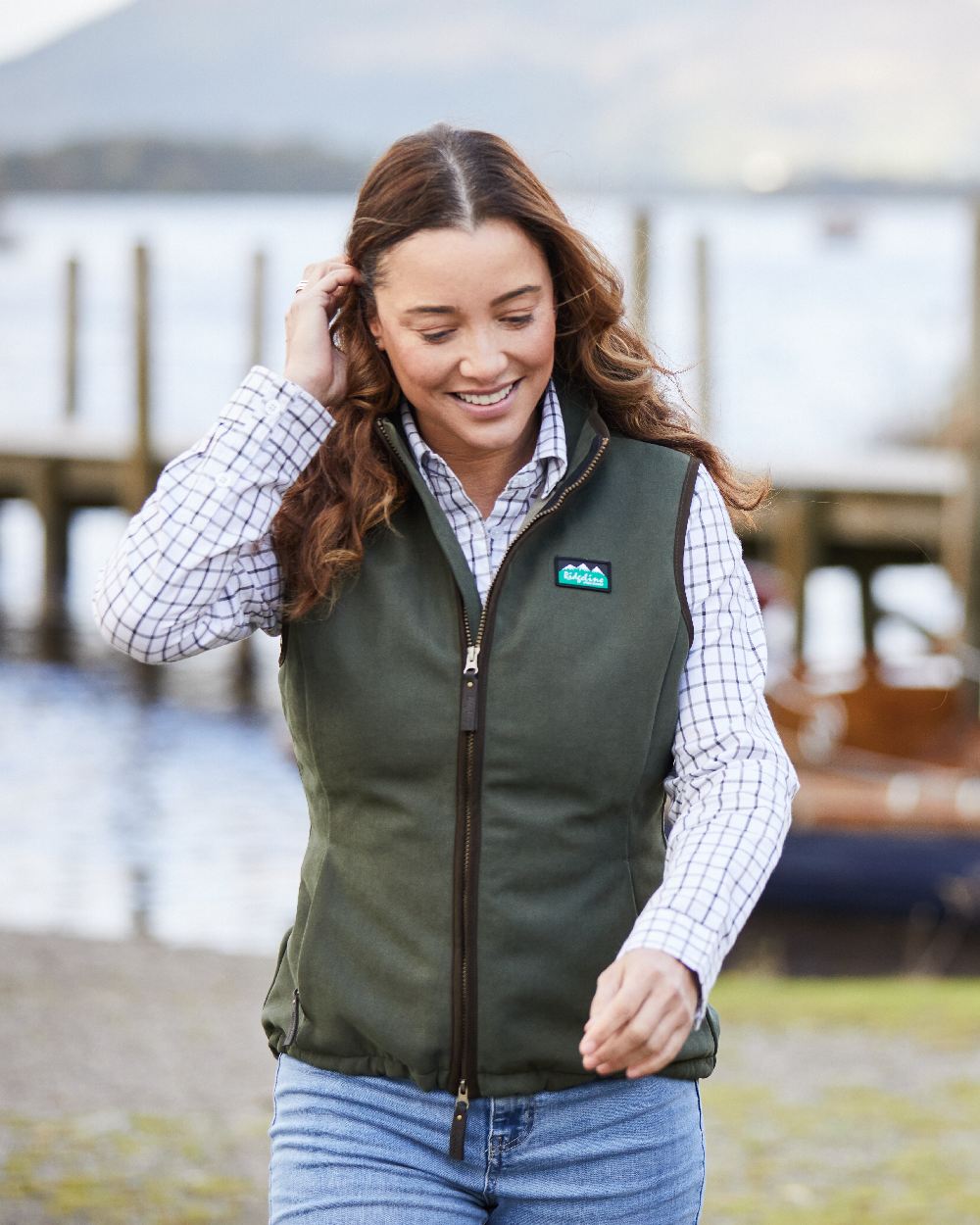 Deep Forest coloured Ridgeline Womens Monarch Gilet on blurry background 