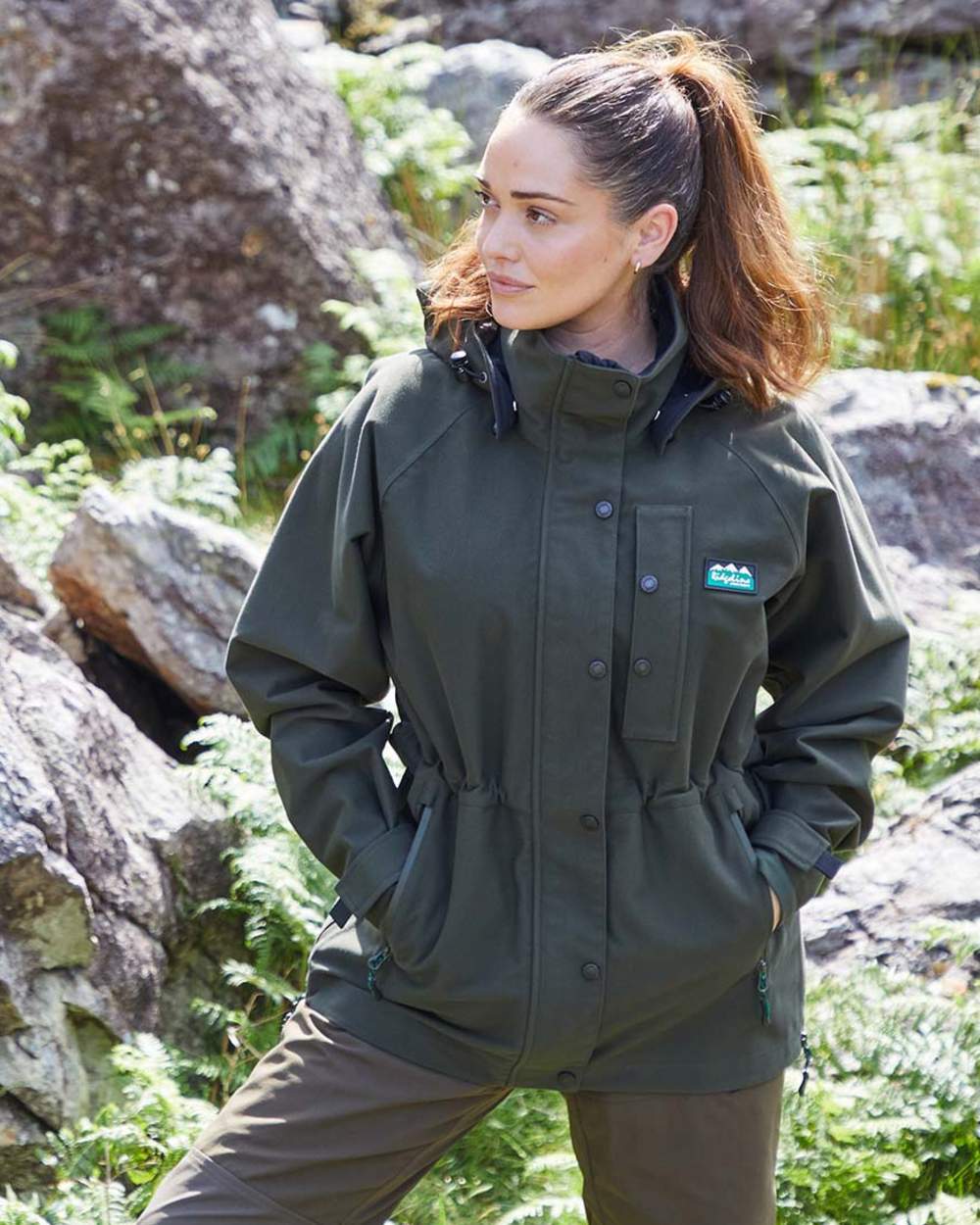 Deep Forest coloured Ridgeline Womens Monsoon Classic Jacket on lake background 