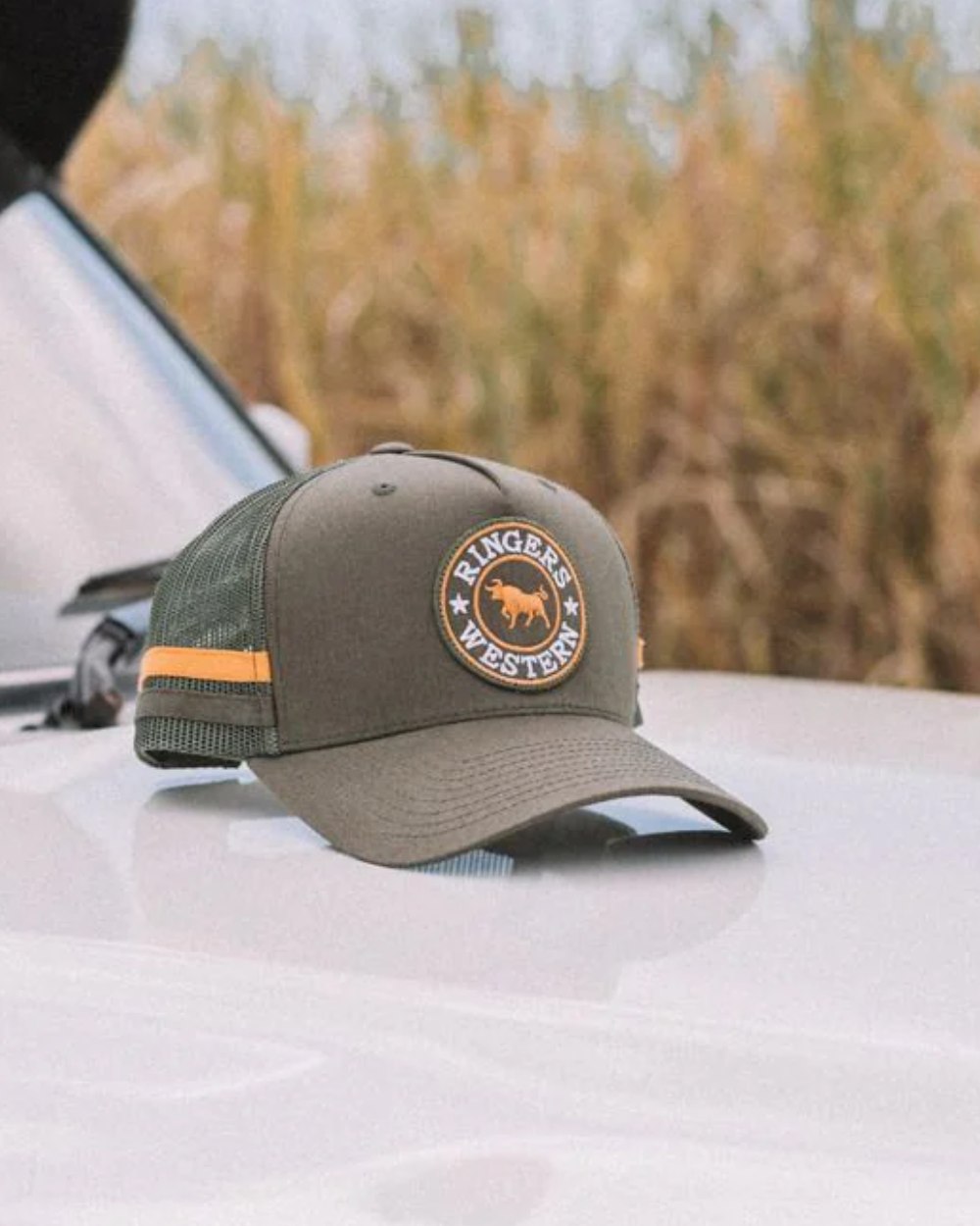 Olive coloured Ringers Western McCoy Trucker Cap on outdoor background 