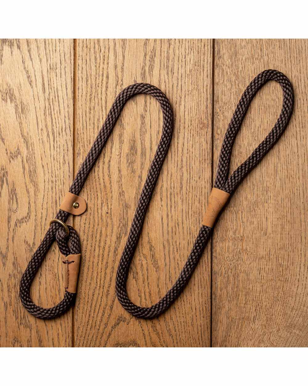 mud coloured Ruff &amp; Tumble Slip Dog Leads on wooden background 