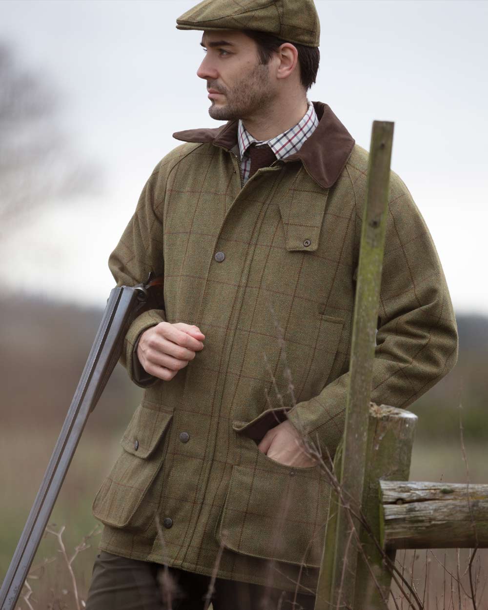 Lichen coloured Alan Paine Rutland Waterproof Tweed Shooting Coat on forest background 
