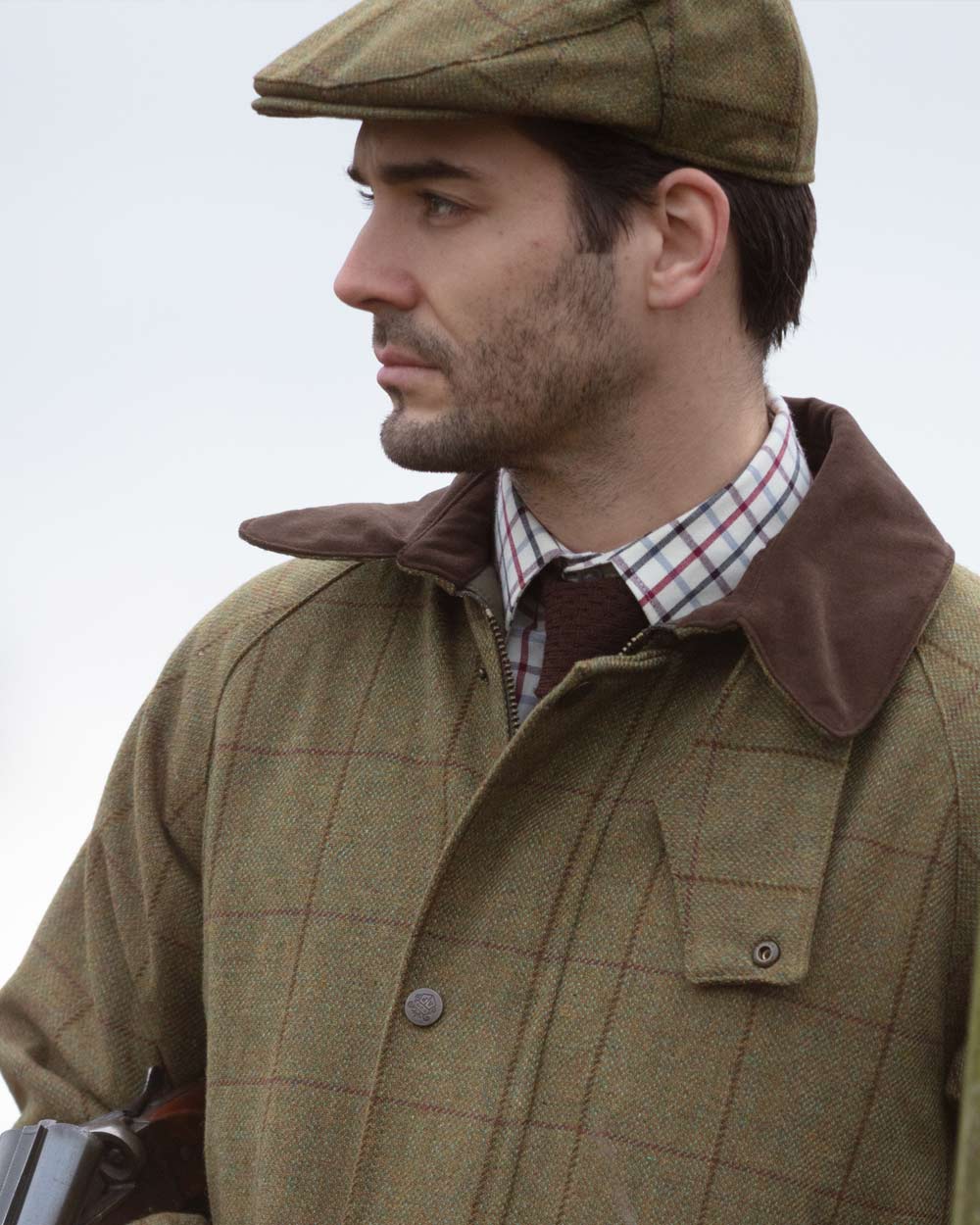 Lichen coloured Alan Paine Rutland Waterproof Tweed Shooting Coat on sky background 