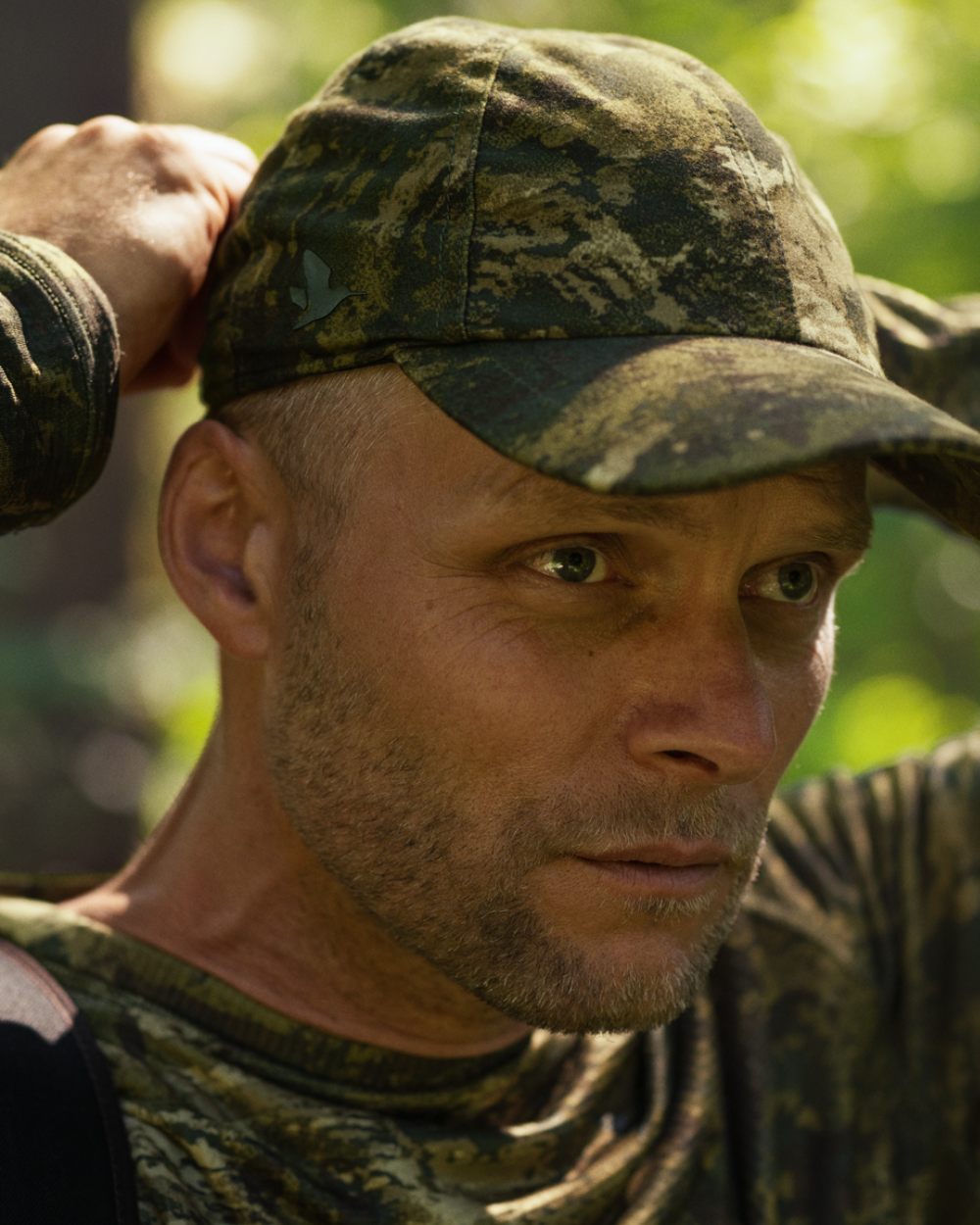 InVis Green Coloured Seeland Avail Camo Cap on forest background 