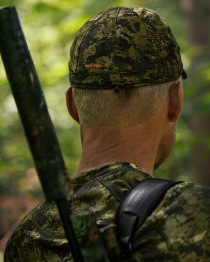 InVis Green Coloured Seeland Avail Camo Cap on forest background 