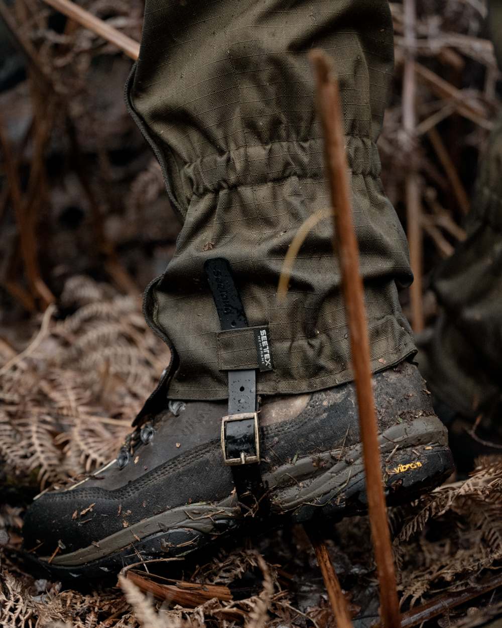 Shaded Olive coloured Seeland Buckthorn Duro Gaiters on forest background 