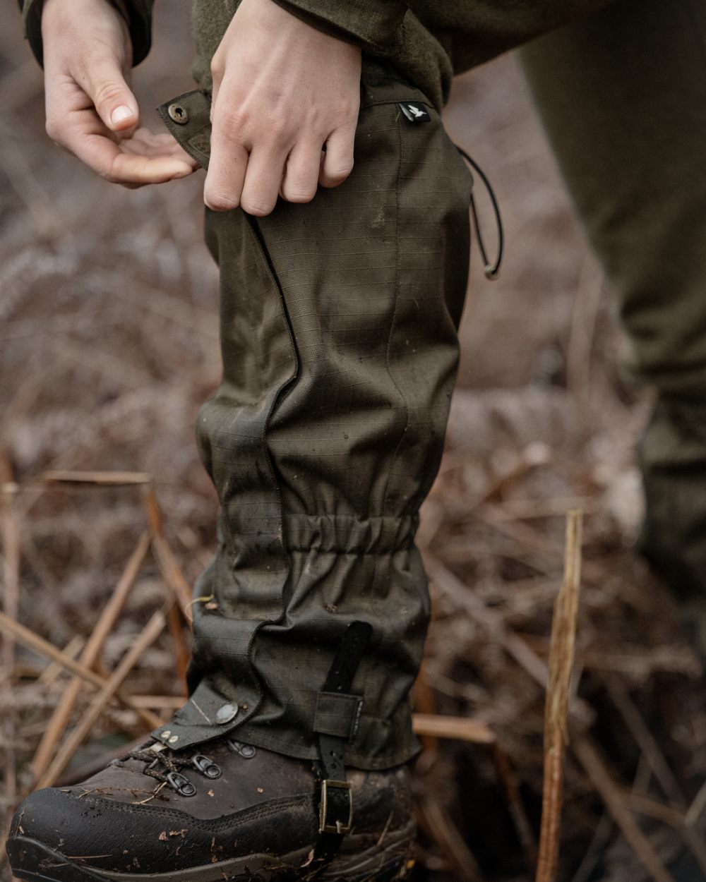 Shaded Olive coloured Seeland Buckthorn Duro Gaiters on forest background 