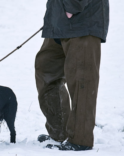 Shaded Olive Coloured Seeland Buckthorn Zip Leg Overtrousers on outdoor background 