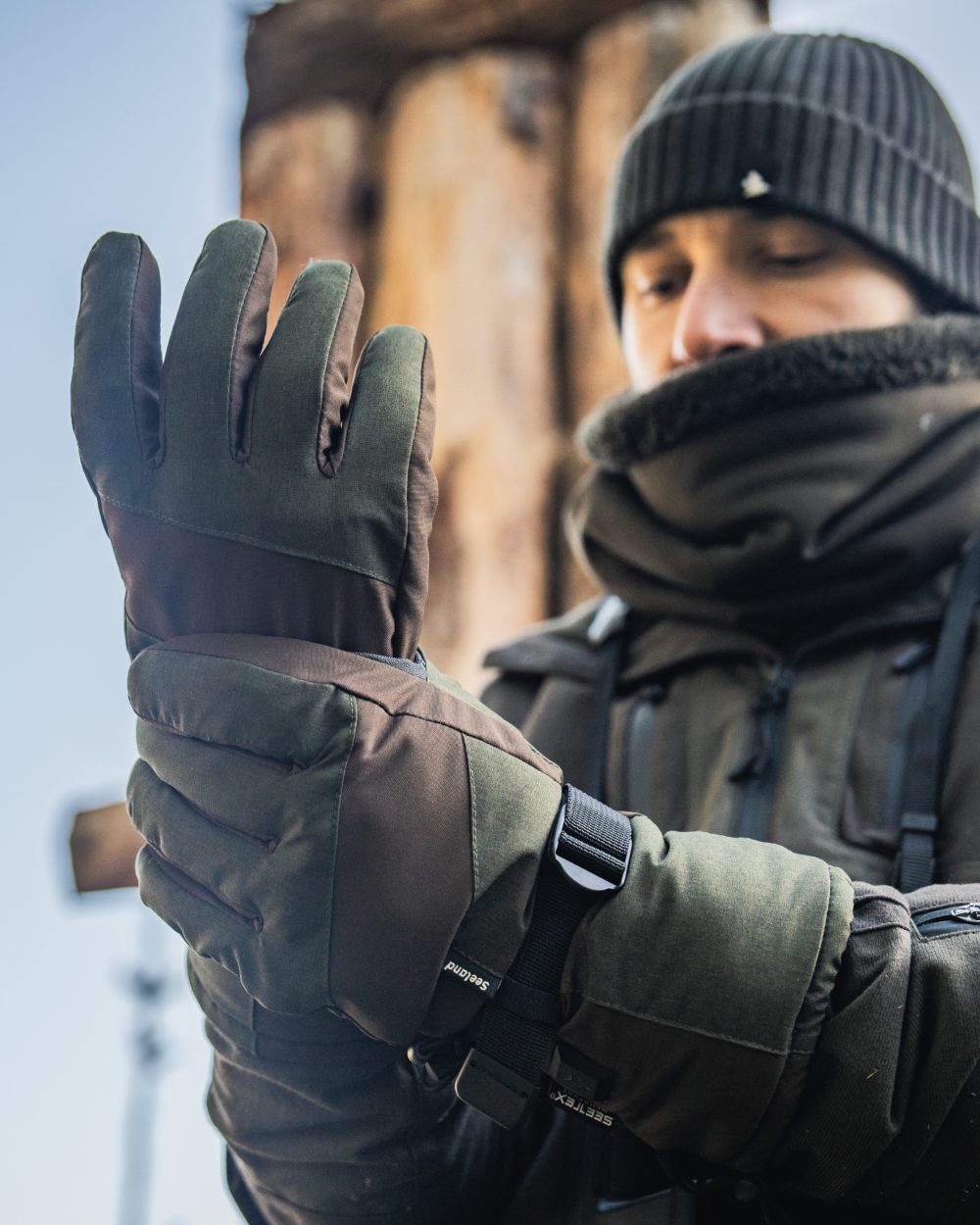 Pine Green coloured Seeland Celsius Heat Gloves on forest background 