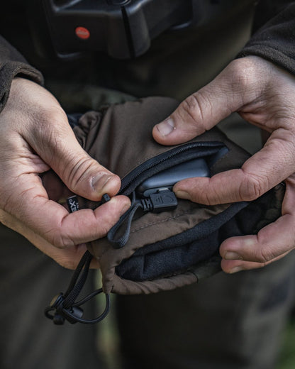 Pine Green coloured Seeland Celsius Heat Gloves on forest background 