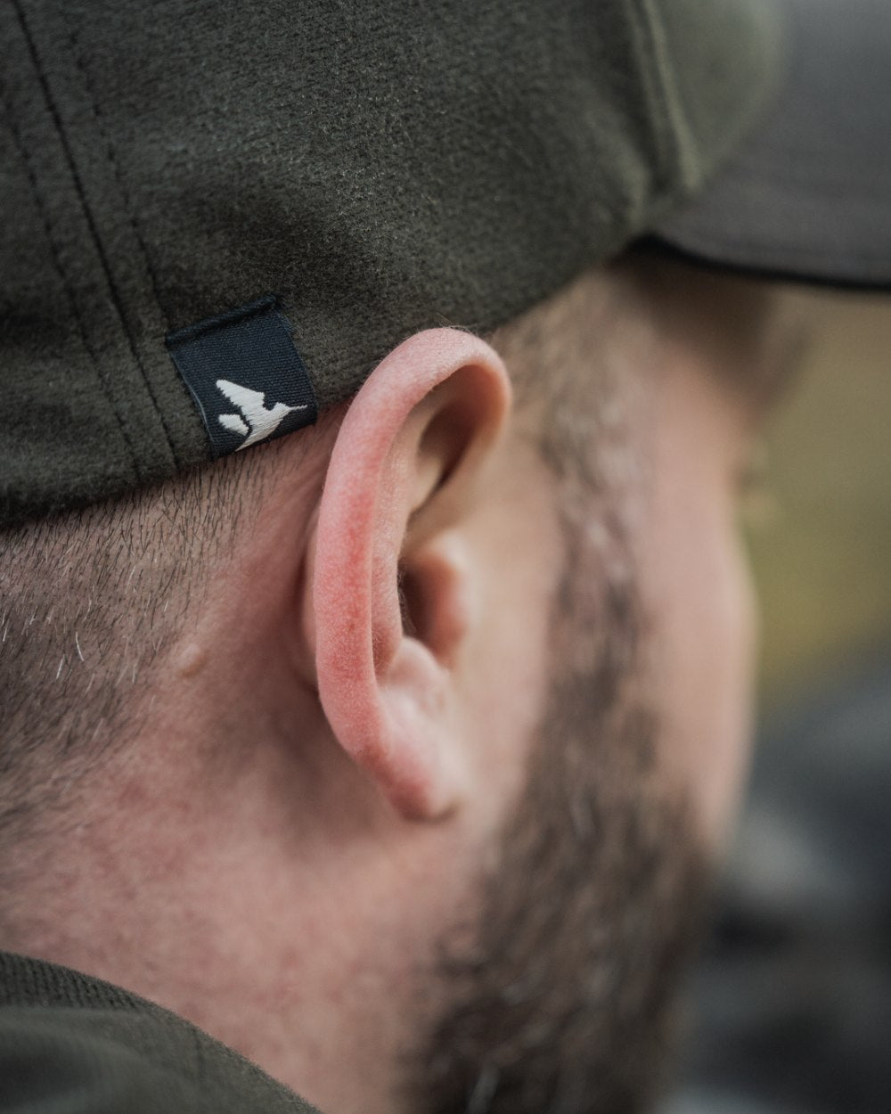 Pine Green coloured Seeland Chaser BGH Cap on forest background 