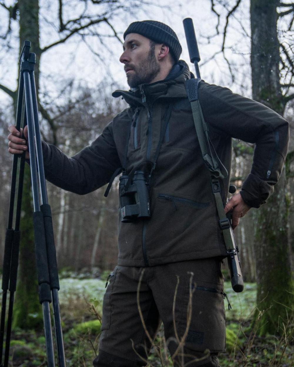 Pine Green Coloured Seeland Chaser Jacket on forest background 