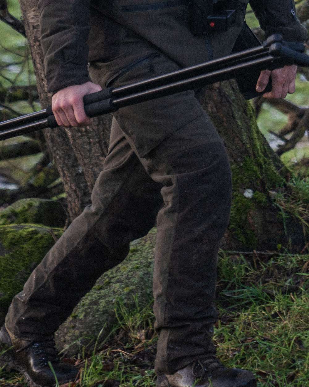 Pine Green Coloured Seeland Chaser Trousers on forest background 