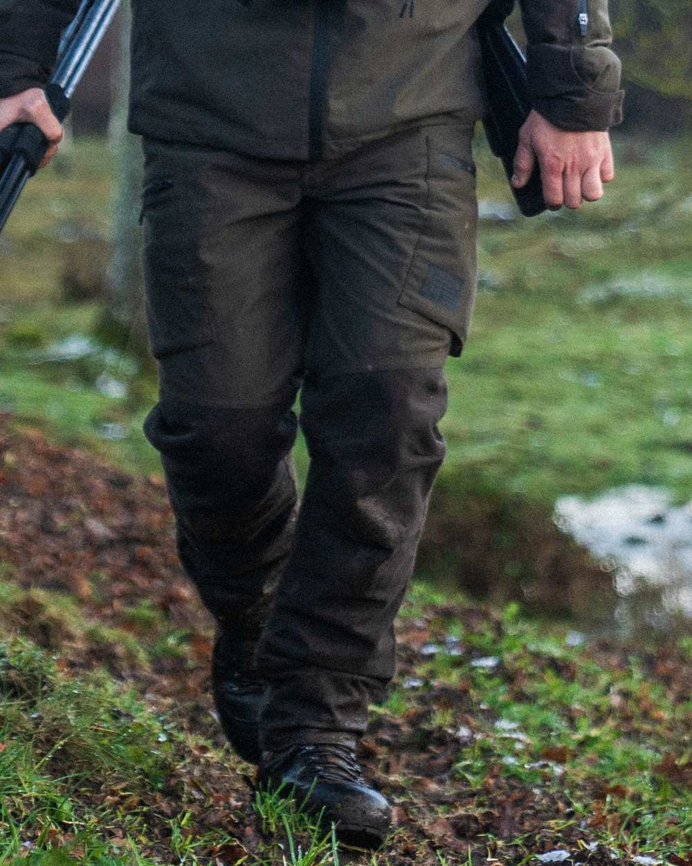 Pine Green Coloured Seeland Chaser Trousers on forest background 