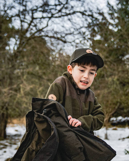 Pine Green Coloured Seeland Childrens Bolt Fleece Jacket on outdoor background 