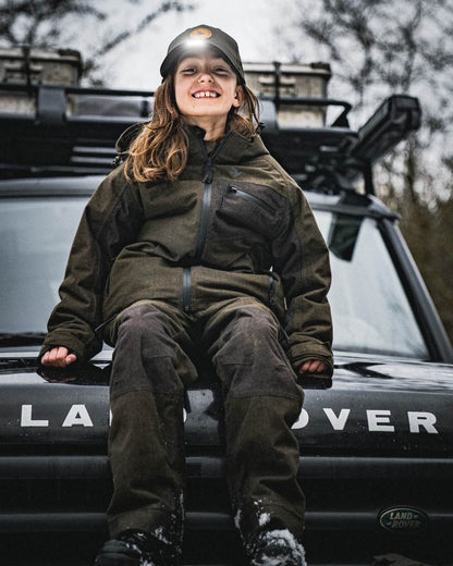 Pine Green coloured Seeland Childrens Skarn LED Junior Cap on forest background 