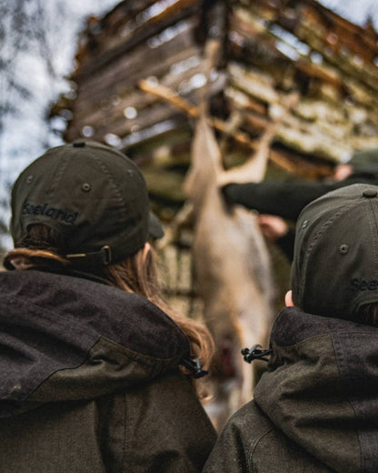 Pine Green coloured Seeland Childrens Skarn LED Junior Cap on forest background 