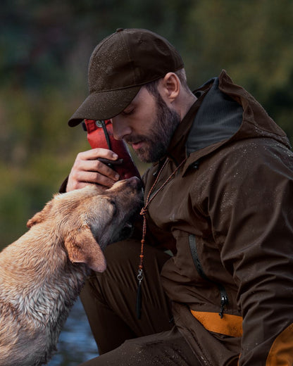 Dark Brown Coloured Seeland Dog Active Jacket On A Forest Background 