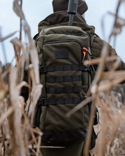 Pine Green coloured Seeland Enduro Backpack on forest background 