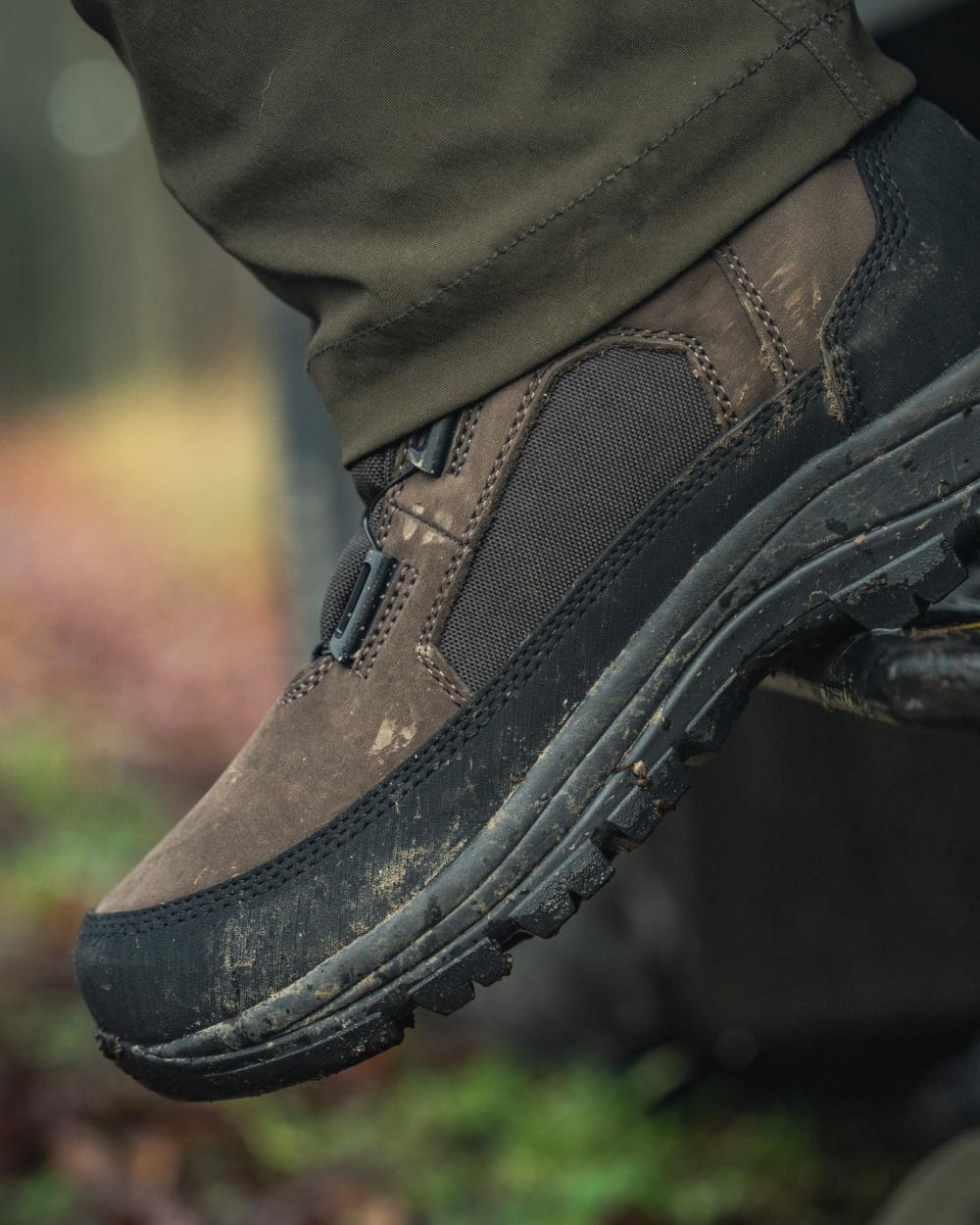 Dark Brown coloured Seeland Enduro Dial Mid Boots on forest background 