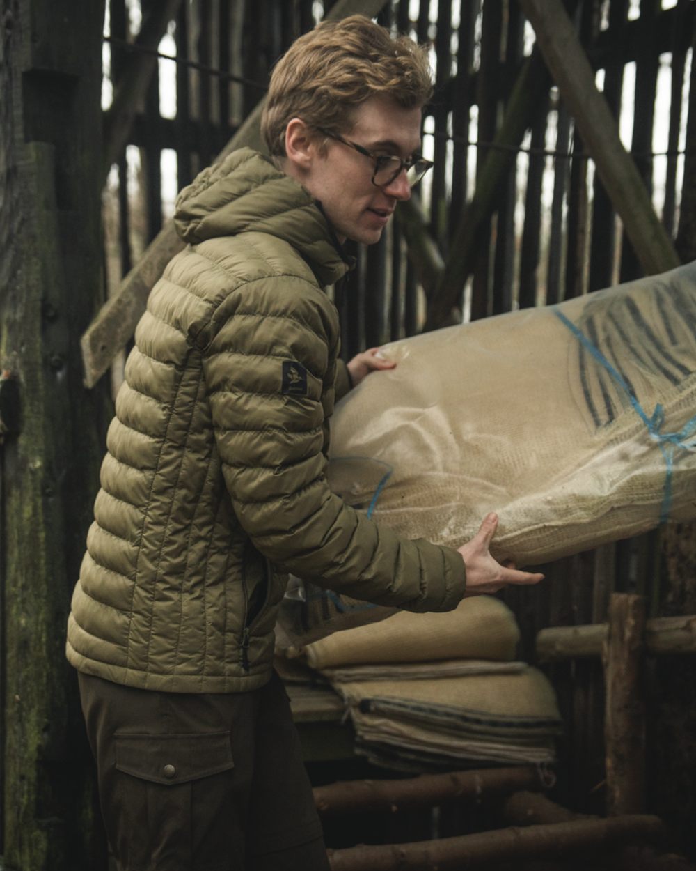Military Olive coloured Seeland Fahrenheit Jacket on forest background 