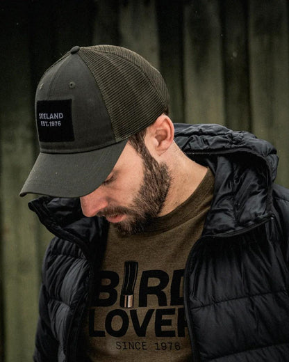 Grape Leaf Coloured Seeland Granite Trucker Cap on forest background 