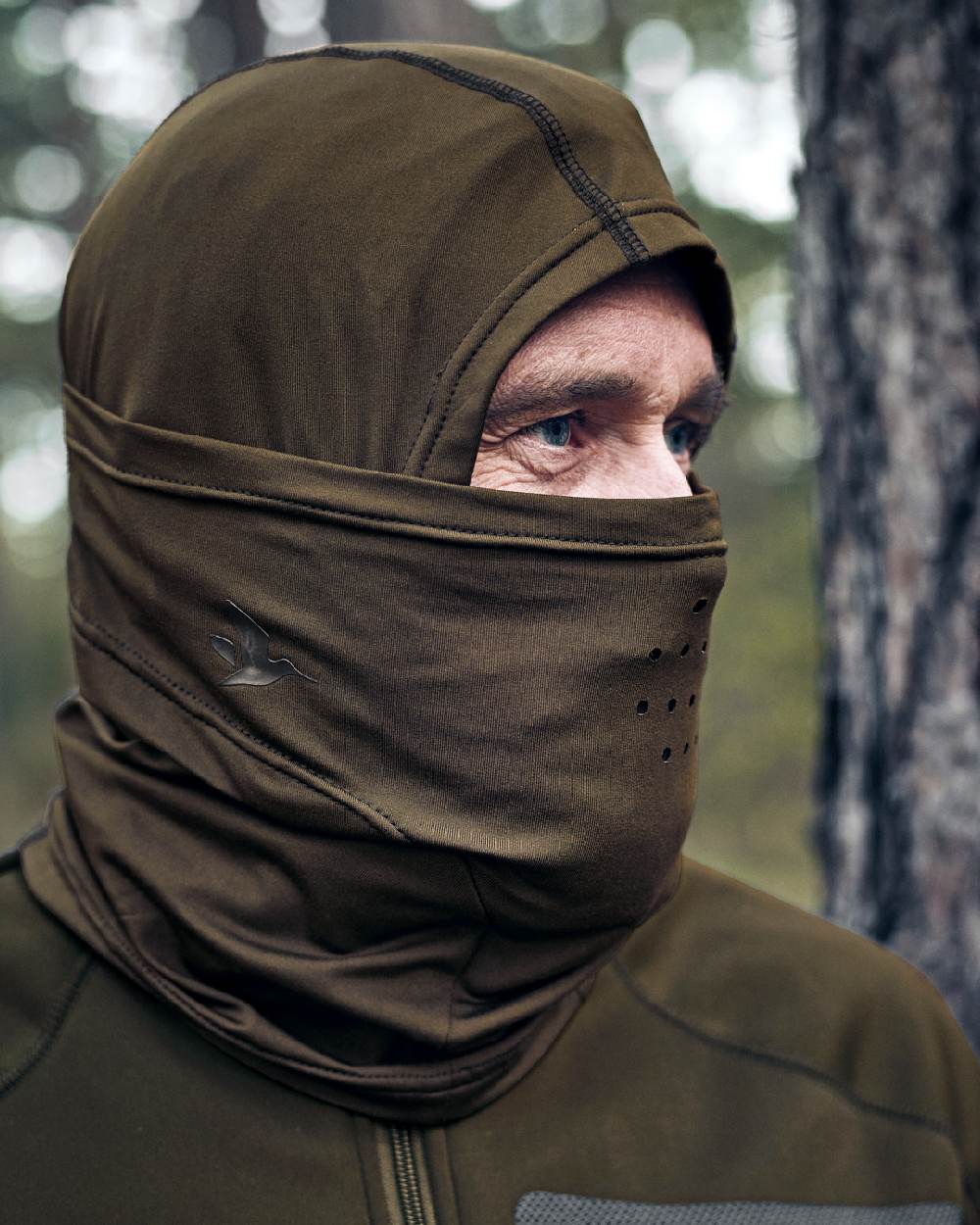 Pine Green Coloured Seeland Hawker Scent Control Balaclava on forest background 