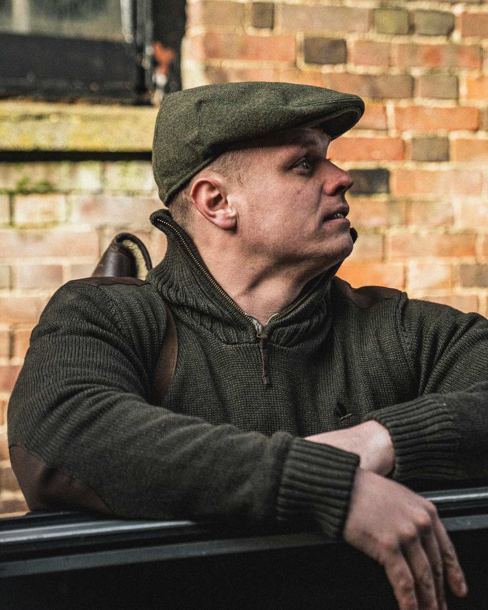 Dark Brown Coloured Seeland Haze Windbreaker Knit On A Wall Background 