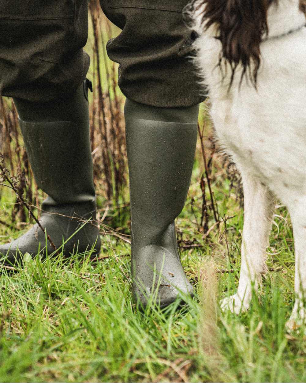 Pine Green Coloured Seeland Hillside Flex Wellingtons on outdoor background 