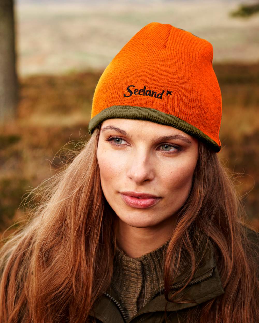 Hi-Vis Orange Pine Green Coloured Seeland Ian Reversible Beanie Hat on outdoor background 
