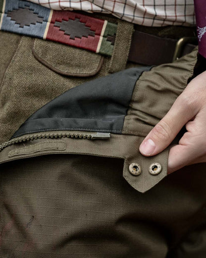 Shaded Olive coloured Seeland Mens Buckthorn Duro Overtrousers on forest background 