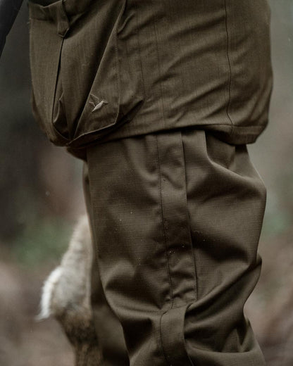 Shaded Olive coloured Seeland Mens Buckthorn Duro Overtrousers on forest background 