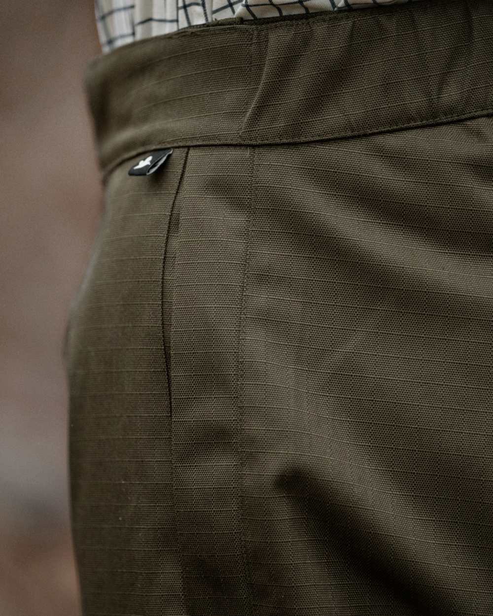 Shaded Olive coloured Seeland Mens Buckthorn Duro Treggings on forest background 