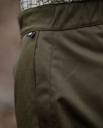 Shaded Olive coloured Seeland Mens Buckthorn Duro Treggings on forest background 