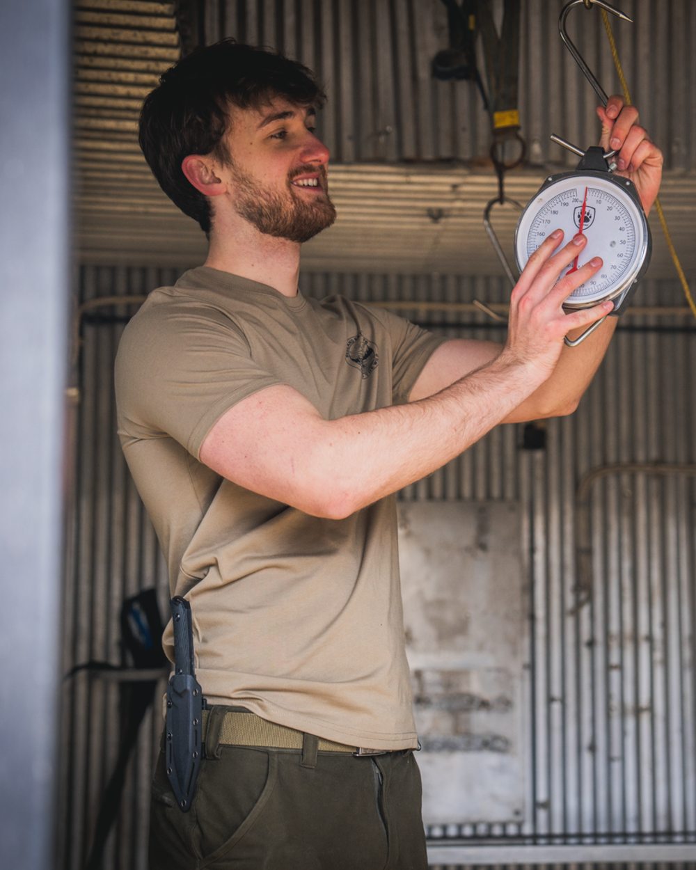 Covert Green coloured Seeland Mens Hunting Landscape T-Shirt on factory background 