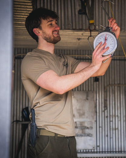 Covert Green coloured Seeland Mens Hunting Landscape T-Shirt on factory background 