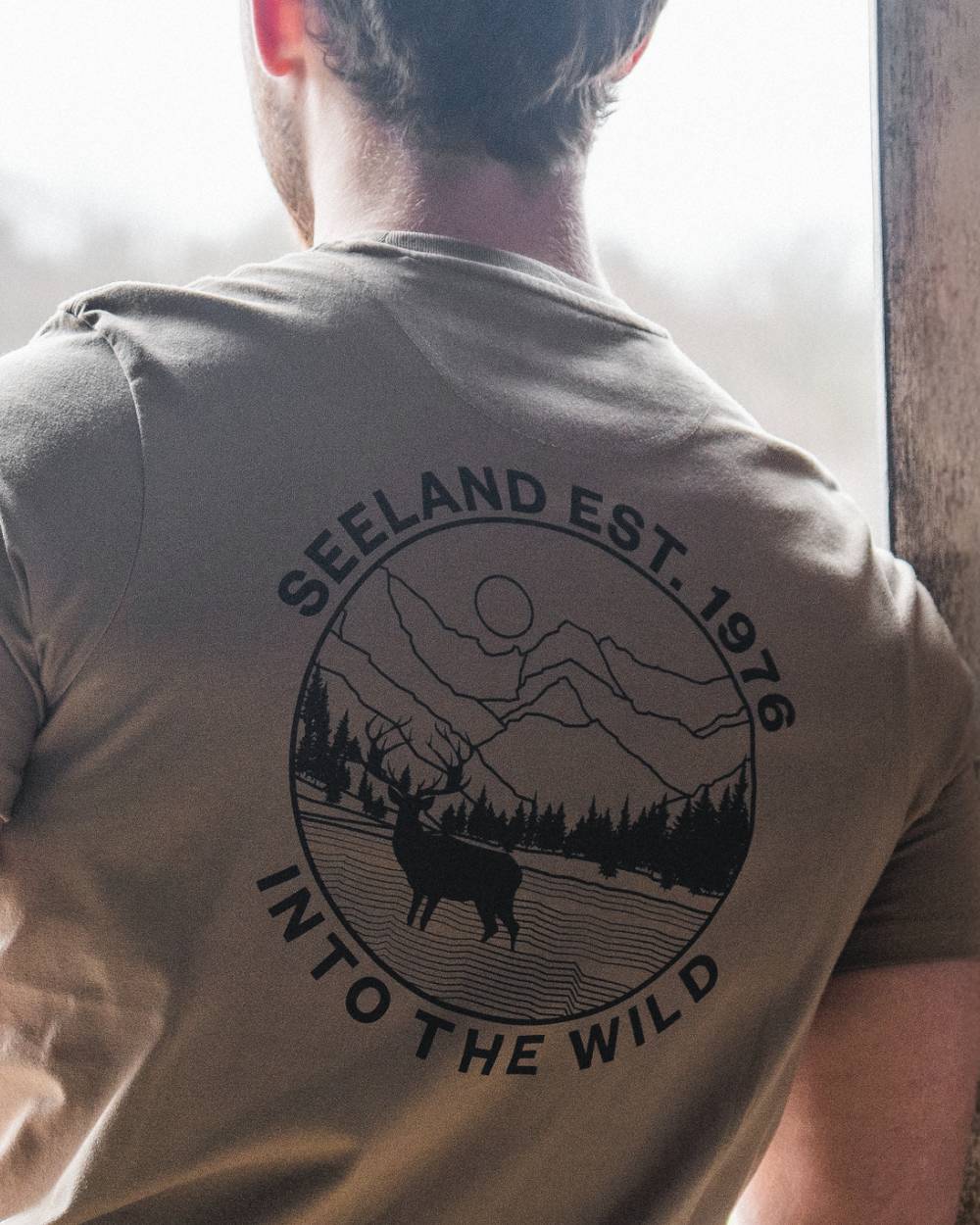 Covert Green coloured Seeland Mens Hunting Landscape T-Shirt on factory background 