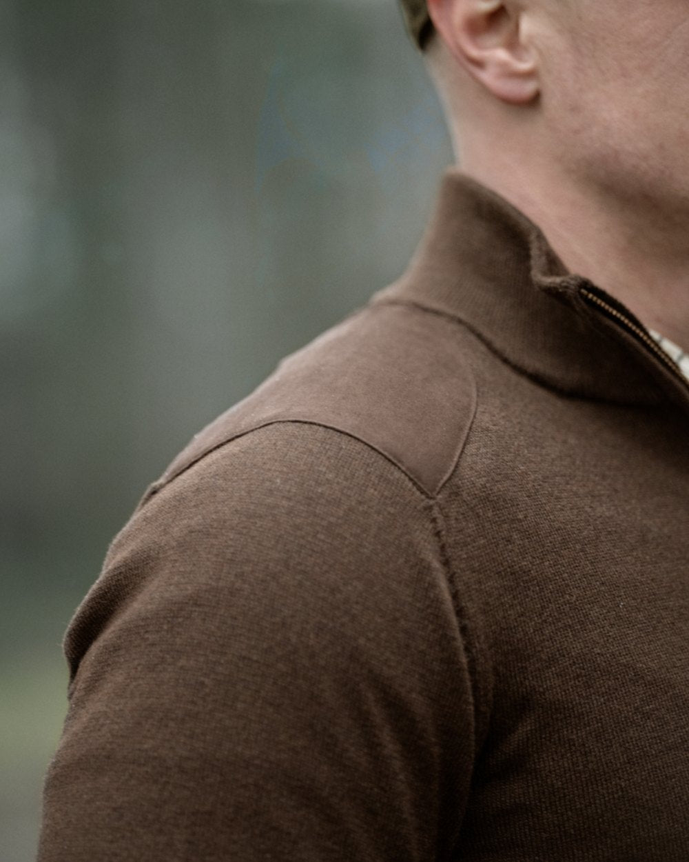 Dark Brown coloured Seeland Mens Pine Half Zip Sweater on forest background 
