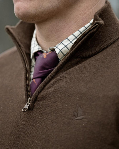 Dark Brown coloured Seeland Mens Pine Half Zip Sweater on forest background 