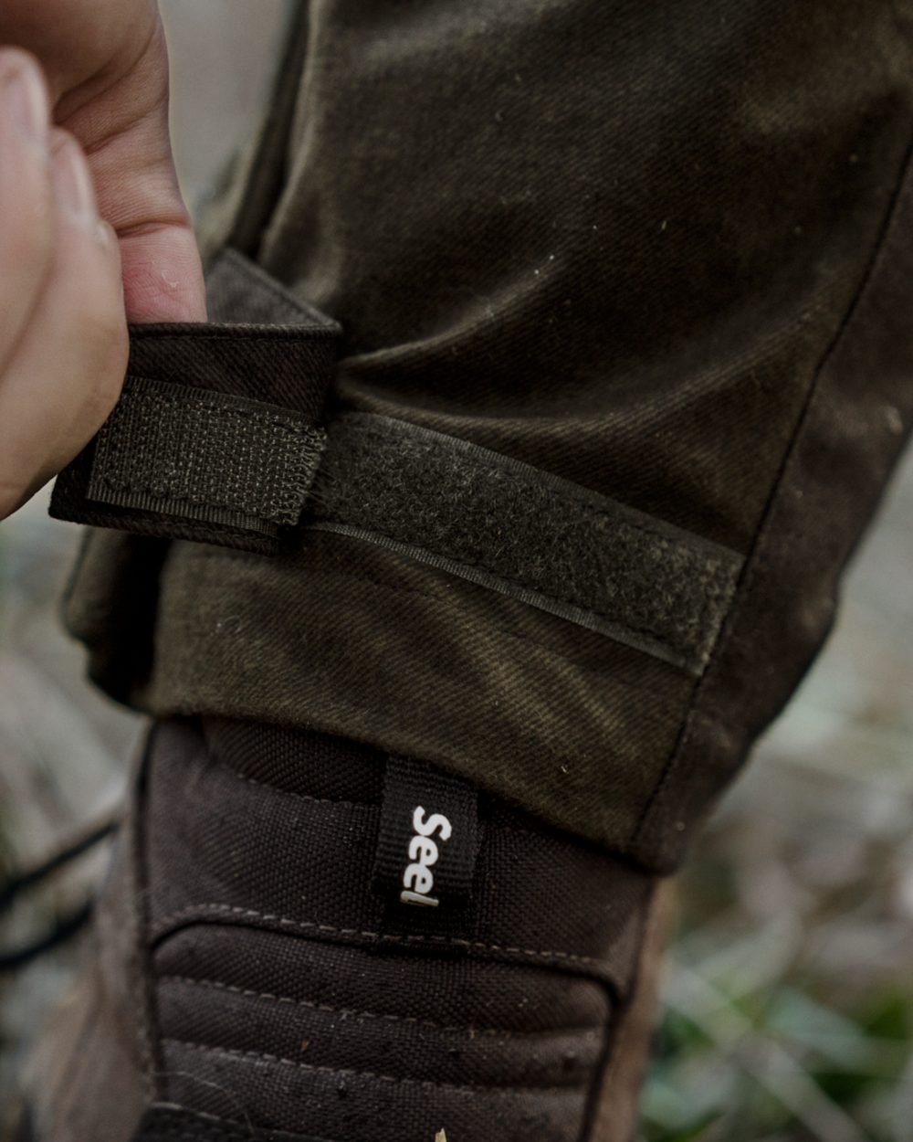 Pine Green Melange coloured Seeland Mens Quest Trousers on forest background 