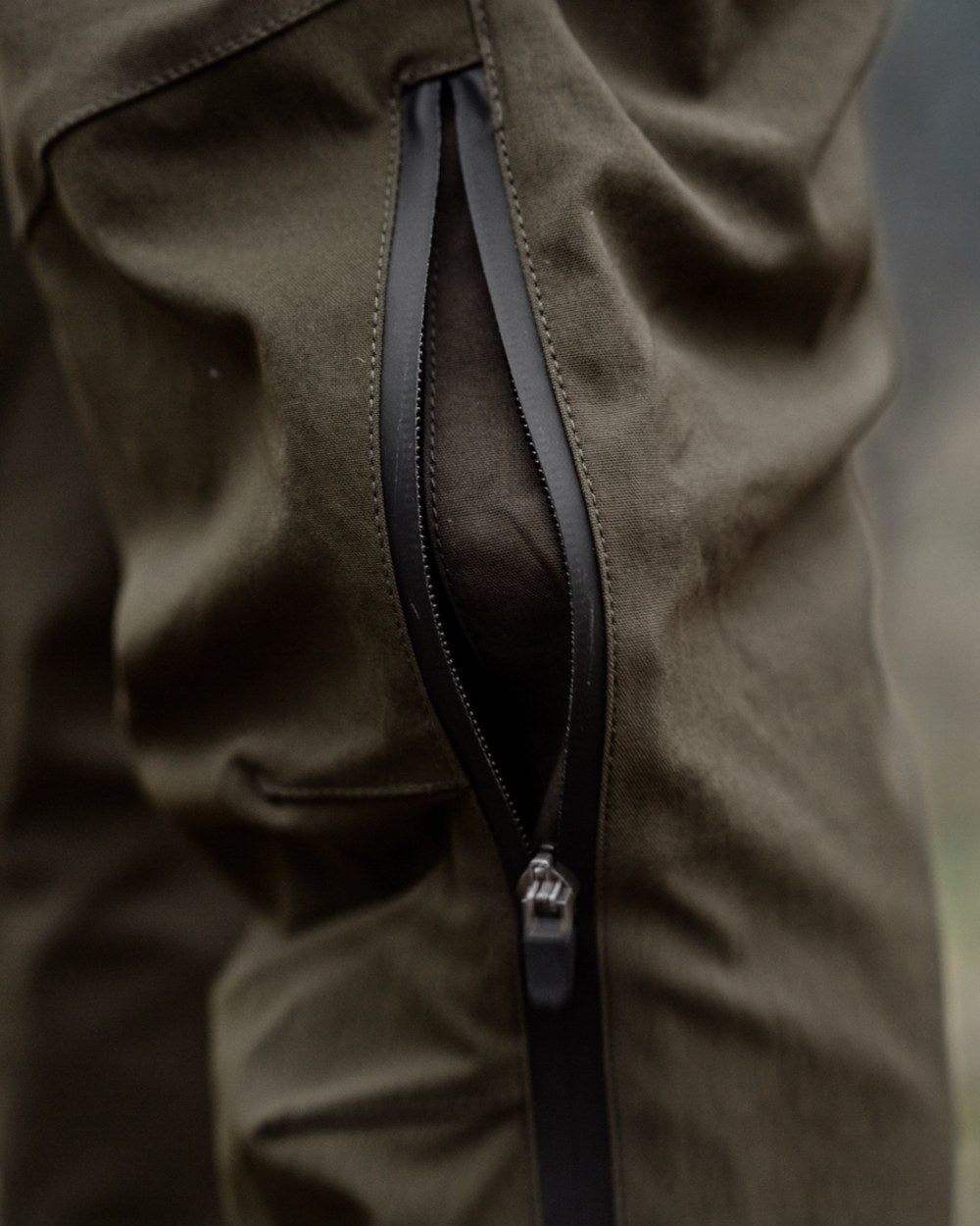 Pine Green Grizzly Brown coloured Seeland Mens Spruce Membrane Trousers on forest background 