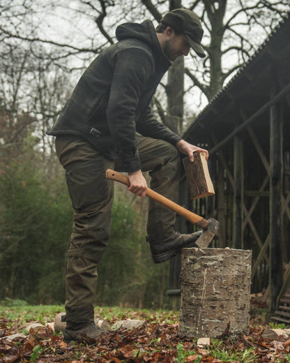 Pine Green coloured Seeland Mens Teddy Fold Down Cap on forest background 