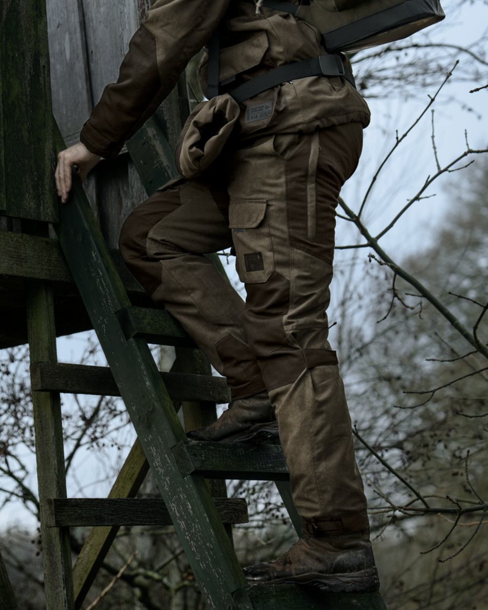 Grizzly Brown coloured Seeland Mens Ultimo Trousers on forest background 