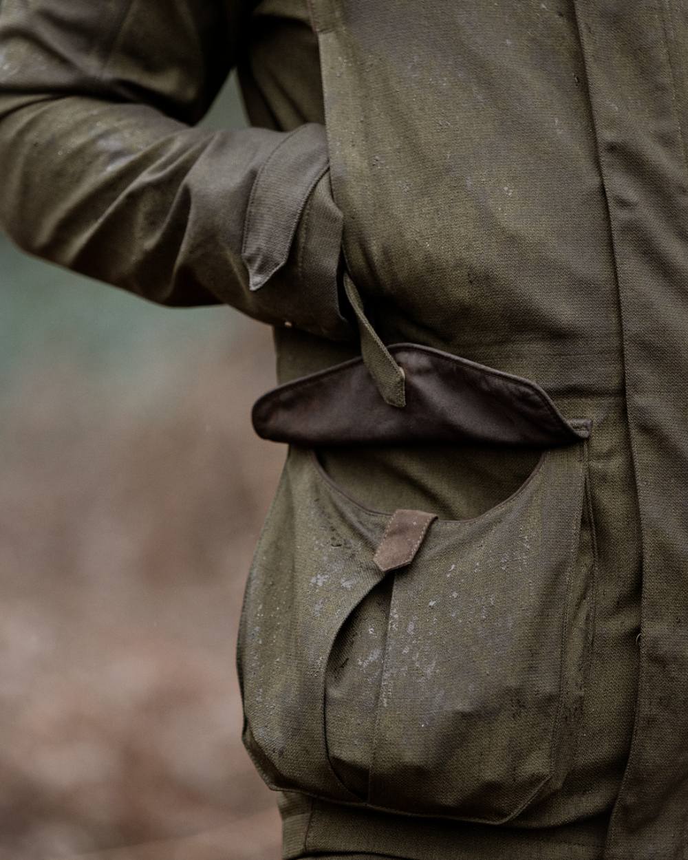 Shaded Olive coloured Seeland Mens Woodcock Royale Jacket on forest background 